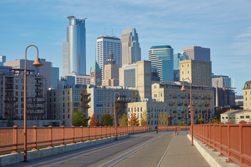 Stone Arch Bridge with downtown Minneapolis Minnesota skyline in the background