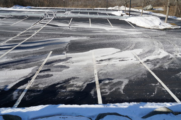 outdoor parking lot with snow removed and sprayed salt