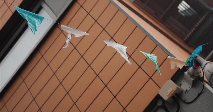 Slow motion shot of flags/bunting blowing in the breeze in Belfast, Northern Ireland.