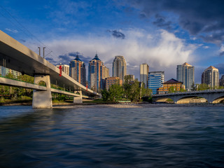 Calgary's skyline across the Bow River in the evening. 