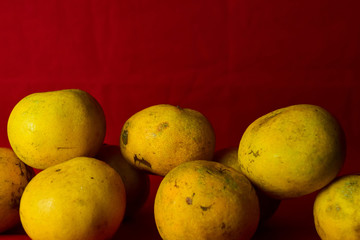 Fresh orange fruit in the red background