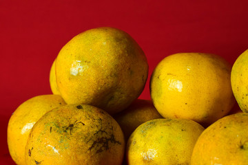 Fresh orange fruit in the red background