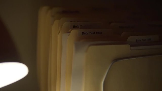 Close up of Beta Test Manilla Folders in Creepy Dark Laboratory