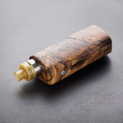 high end rebuildable dripping atomizer with stabilized natural wood regulated box mods, vaping device, selective focus with shallow depth of field