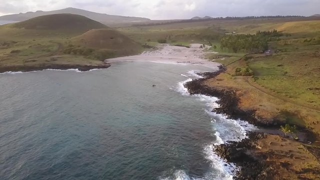 Aerial drone footage Anakena Beach an amazing, idyllic and wild beach in the Pacific Ocean at Easter Island an amazing travel destination with the Moais mystery like Ahu Nau Nau in Anakena beach 2/4