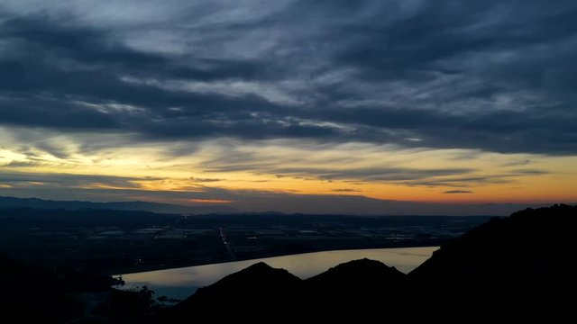 Hyper-Lapse drone 4k night image looking over Perris Lake as the sun sets.