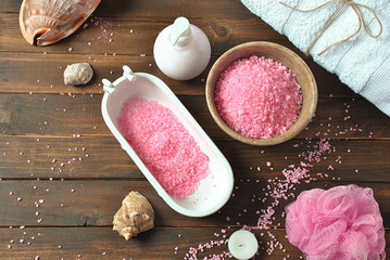 Fototapeta na wymiar Dead Sea cosmetics. Spa and body care products. Aromatic rose bath Dead Sea Salt on the dark wooden background. Natural ingredients for homemade body salt scrub. Beauty skin care. 