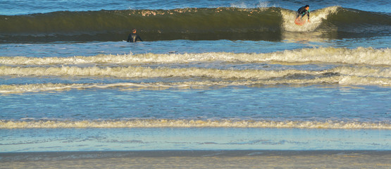 Fototapeta na wymiar Surfers in the Atlantic, Jacksonville Beach, Duval County, Florida