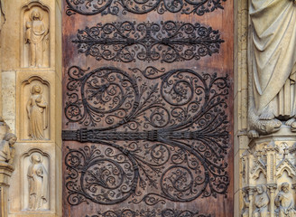 Intricate wrought iron vintage scroll work on the door hinges of Notre Dame de Paris Cathedral in Paris France forged metal hinges on the doors of Notre Dame de Paris Cathedral in Paris France