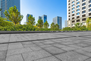 empty pavement and modern buildings in city.