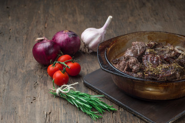 Goulash, beef stew in glass  baking dish on dark background,