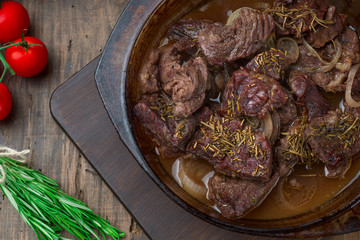 Goulash, beef stew in glass  baking dish on dark background,