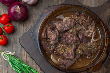 Goulash, beef stew in glass  baking dish on dark background,