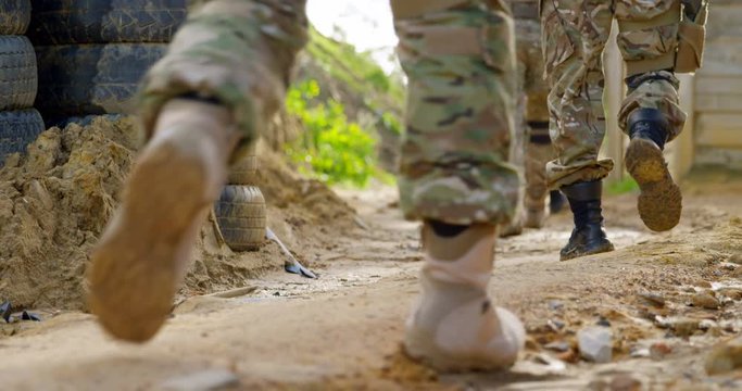 Low section of military soldiers walking during military training 4k