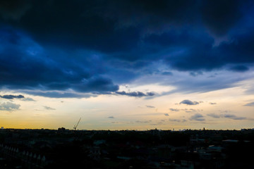 Raining cloud over skyscraper of modern city building