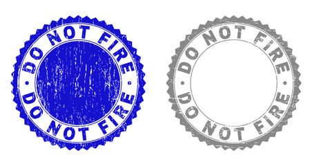Grunge DO NOT FIRE stamp seals isolated on a white background. Rosette seals with grunge texture in blue and gray colors. Vector rubber stamp imprint of DO NOT FIRE title inside round rosette.