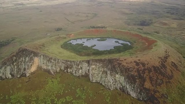 Aerial footage view over Rano Raraku Crater Lake Moais quarry where were built, some Moai still stay on the quarry waiting to one day reach there final destination, awe landscape at Easter Island