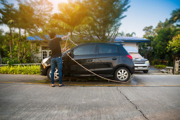Fototapeta premium Man cleaning car,Car parked on street