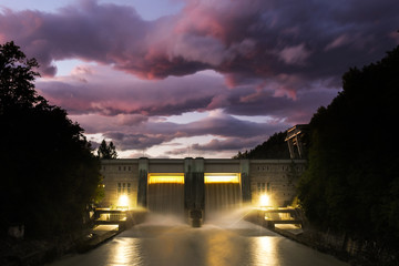Fototapeta na wymiar Small hydro dam electricity power station with beautiful sunset in Medvode, Slovenia