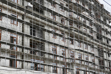 new building under construction, scaffolding and concrete