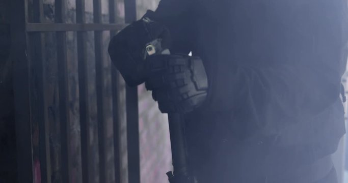 Mid section of soldier throwing smoke grenades in building during military exercise 4k