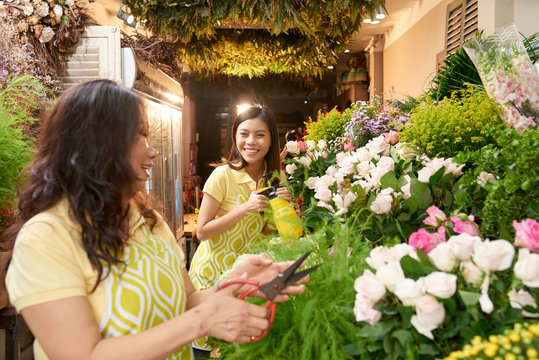 Mother and daughter working in flower shop