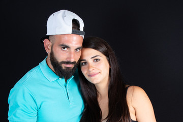 couple in love hug beauty woman young and handsome bearded man on black background