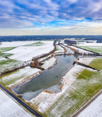 The Schwafheimer sea is a nature conservation area in Moers in a former flood gutter of the river Rhine in Germany - Aerial view with the chimneys of Duisburg city in the background