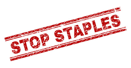 STOP STAPLES seal print with distress effect. Red vector rubber print of STOP STAPLES caption with dust texture. Text caption is placed between double parallel lines.