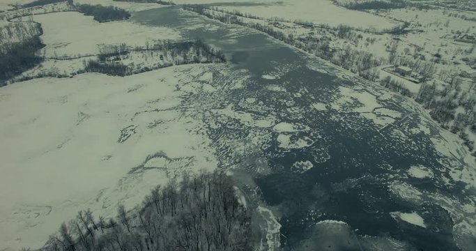 Aerial Top Down View To The Ice Pattern River.Drone Frozen Lake Covered Ice.Top View Of Beautiful Ice Texture.Ice Pattern On River From Drone.Rising Aerial View Of Ice Sheets On Frozen Lake Viewing.