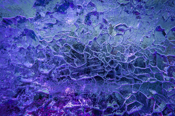 Violet light. Ice texture background. Close-up.Soft focus.