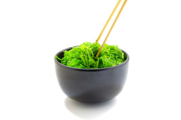 Hiyashi Wakame Chuka or seaweed salad in black bowl on white background ,Japanese food