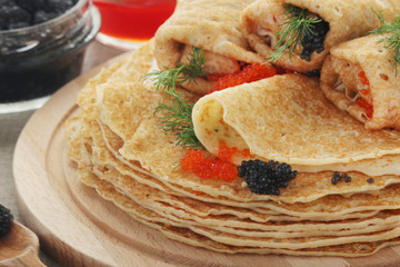 Russian pancakes with red and black caviar