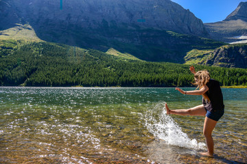 Girl splashing water with her leg
