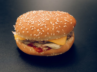 fast food. tasty hamburger on a dark background.