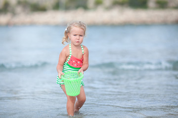 Little cute happy girl swims in the sea, Spain