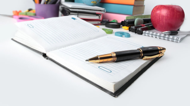close up.notebook, pen and school supplies isolated on white background.photo with copy space