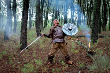 Fototapeta premium Bloody real viking with his sword training for combat
