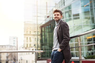 young elegant man in front of a hotel