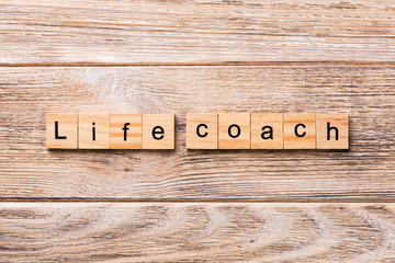 Life coach word written on wood block. Life coach text on wooden table for your desing, concept