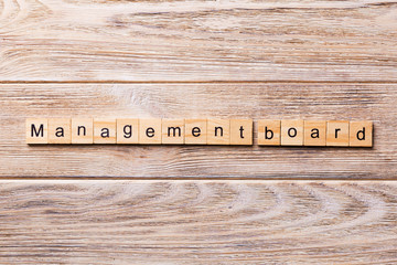 Managenment board word written on wood block. Managenment board text on wooden table for your...