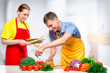 couple in love is cooking together a healthy and tasty vegetable salad