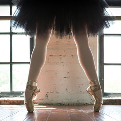 Legs of a ballerina closeup. The legs of a ballerina in old pointe. Rehearsal ballerina in the...