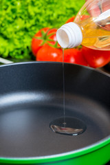 close-up hot pan, which is poured sunflower oil for cooking