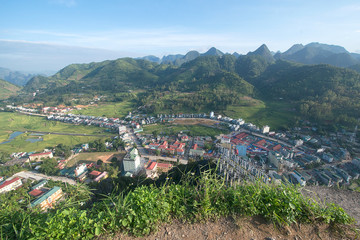 Fototapeta premium Town and karst mountains near Don Van, Ha Giang province, North Vietnam 