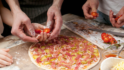 Horizontal Food Banner. Moms, daughters and son hands cook homemade pizza together. Close-up