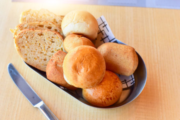 Bread Assortment Isolated on Wooden Table with Knife