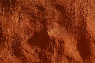 close-up: plastered, rough orange wall, illuminated by bright side lights. With scratches, deep shadows and contrast 4