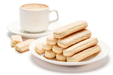 White ceramic cup of coffee with a savoiardi ladyfinger cookie on a plate