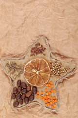 Dried lemon, coffee beans, cereals in a rope star